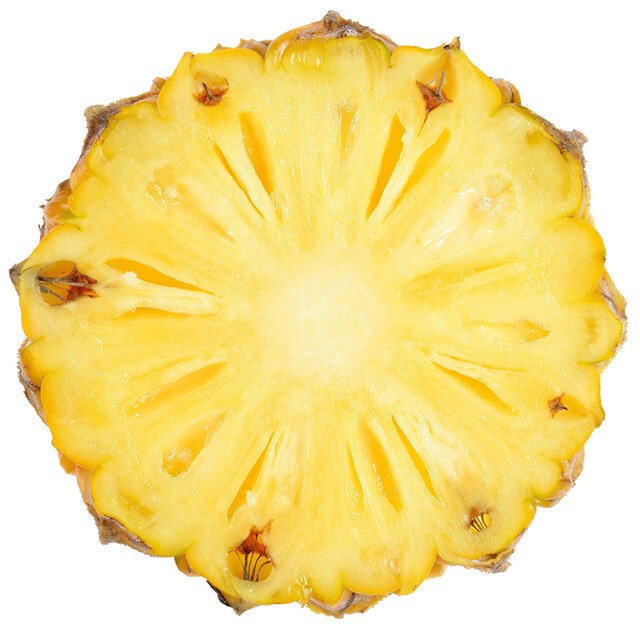 A circular slice of pineapple, resembling the sun