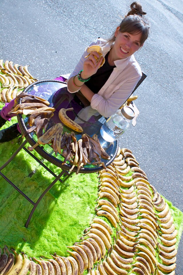 Ashley Clark is roadside and surrounded by bananas on a green carpet