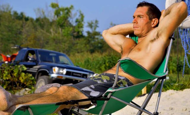 Korey Constable tanning on a beach