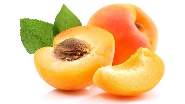 Whole and halved apricots on a white background