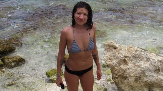 Apryl Electra Storms poses in a swimsuit on a beach