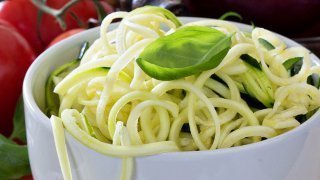 Zucchini noodles in a bowl with fresh tomatoes