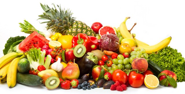 A spread of fruits and vegetables on white background