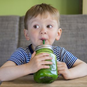 Ball Mason Jars and mason jar accessories - boy sipping green smoothie - Fruit-Powered Store