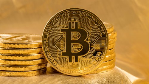 Cryptocurrencies - Bitcoin - standing and stacked on gold background - Fruit-Powered