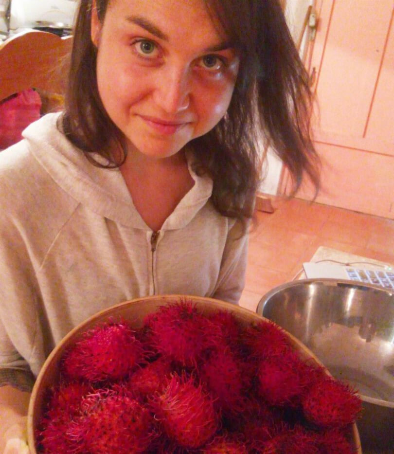 Aliyah Washington holds a bowl of rambutans