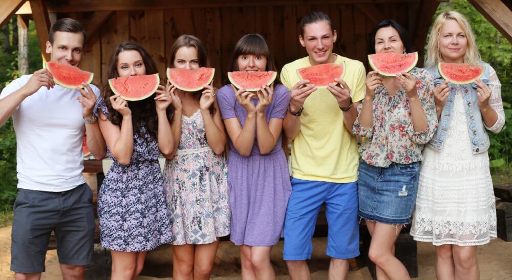 Importance of eating organic fruit - friends eating watermelon - Fruit-Powered