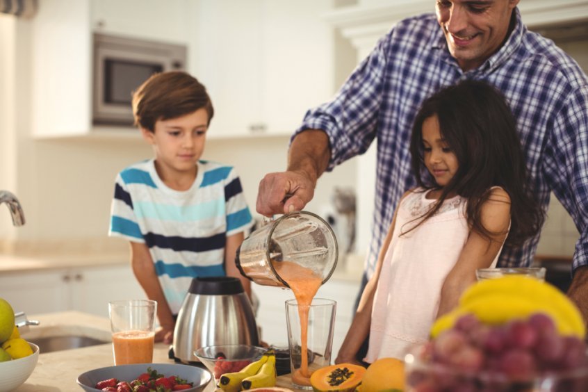 Healthy school lunches - father, son and daughter making fruit smoothie recipes - Fruit-Powered