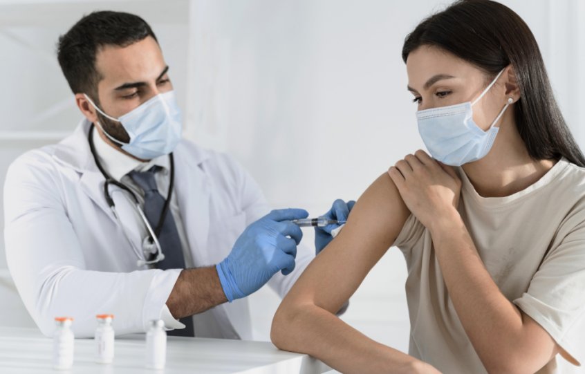 COVID vaccine - doctor injects woman - Fruit-Powered
