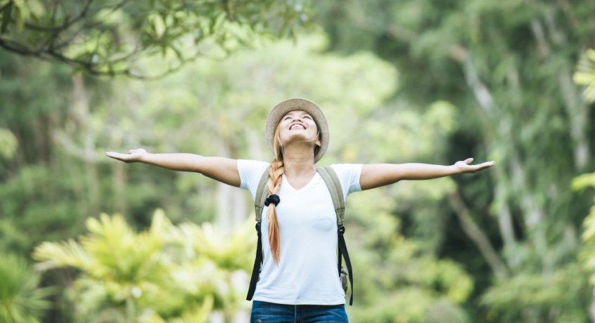 Nature's laws - woman with arms outstretched in nature - Fruit-Powered