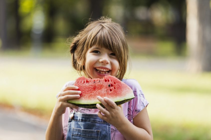 Autism symptoms and causes - healing autism naturally - girl eating watermelon - Fruit-Powered