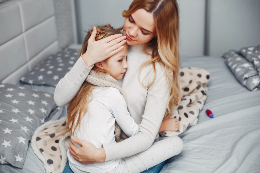 Mother consoling child sick from vaccine injection - Fruit-Powered